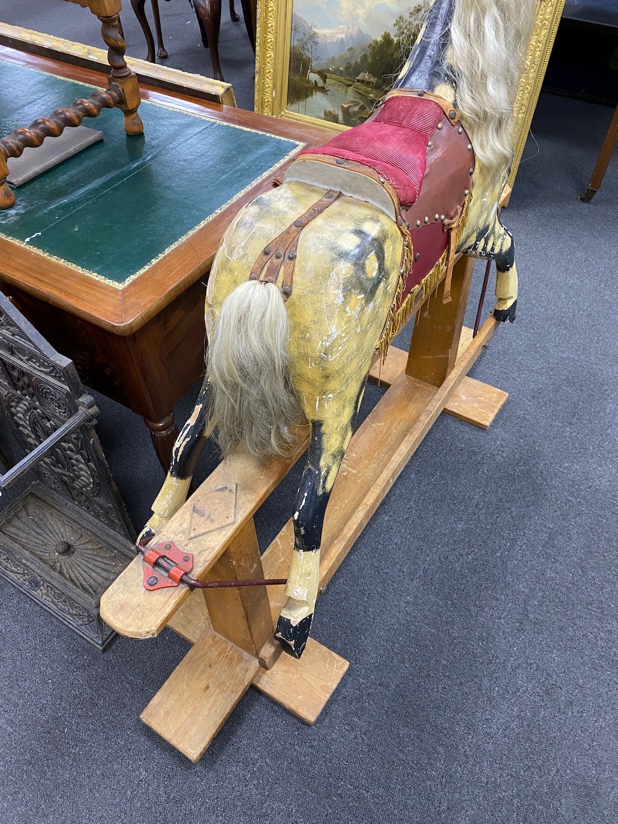 A mid 20th century Ayres type dapple rocking horse on pine safety frame height 122 cms